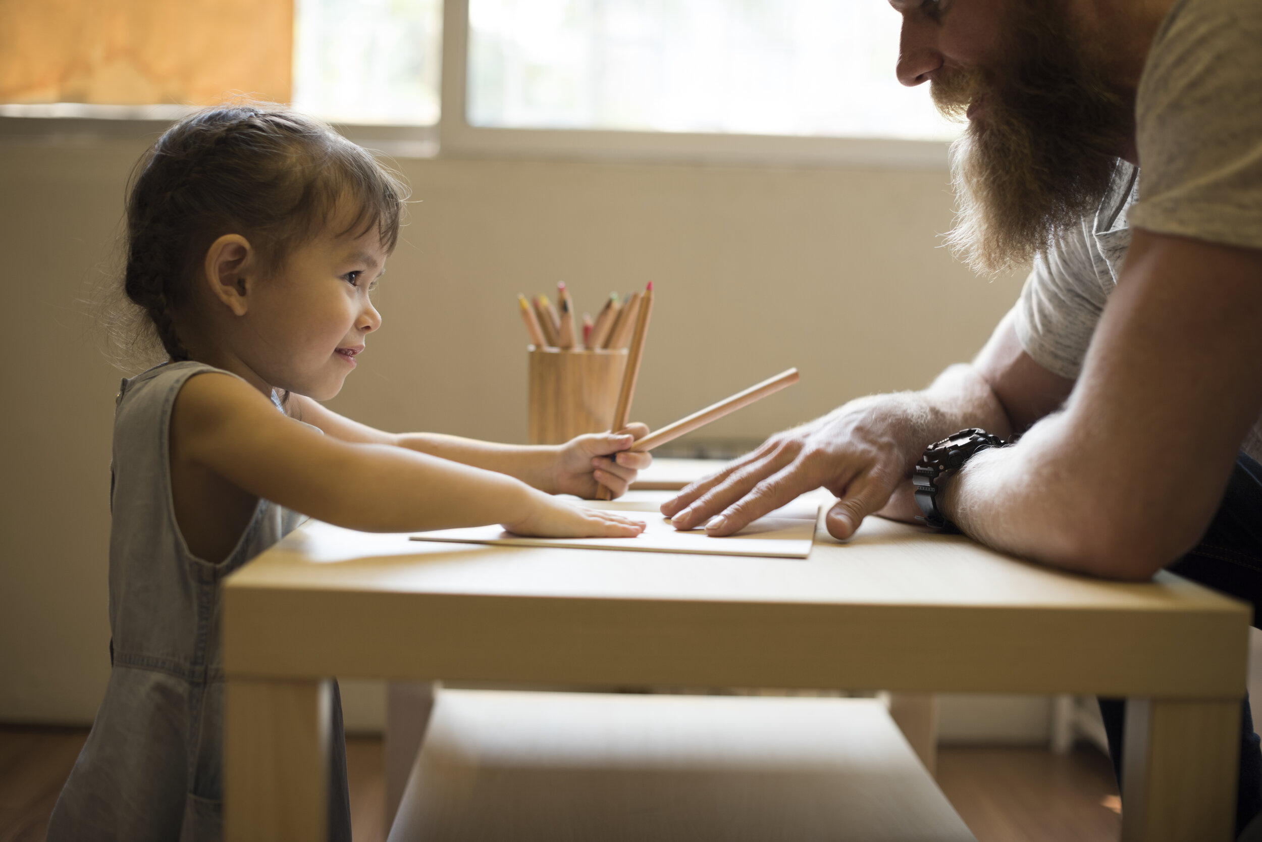 Parent and child drawing together